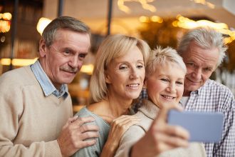 group-senior-friends-taking-photo-social-media